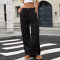 Wide-leg black cargo pants with side pockets, worn by a model in an urban setting. Perfect for rebellious souls.
