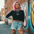 A model with pink hair wears a black oversized crewneck flaunting bold 'PSYCHO BITCH' text against a graffiti backdrop.