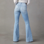 Light wash flared denim jeans with fitted waist and back pockets, perfect for bold fashion choices.