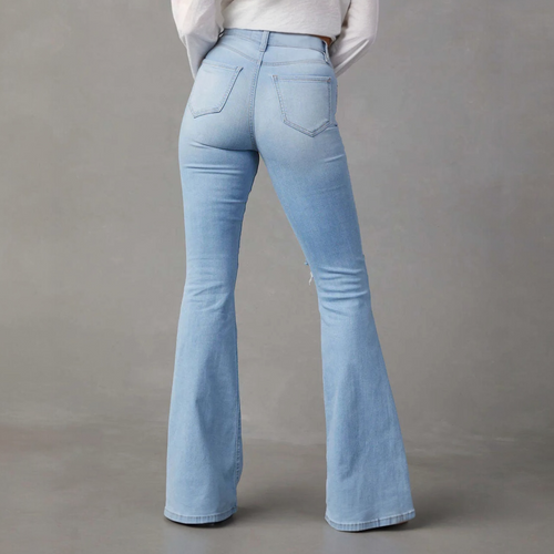 Light wash flared denim jeans with fitted waist and back pockets, perfect for bold fashion choices.