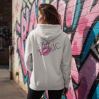 Pretty Toxic Signature Hoodie worn by a model in an urban setting, featuring a large back graphic and kiss mark.